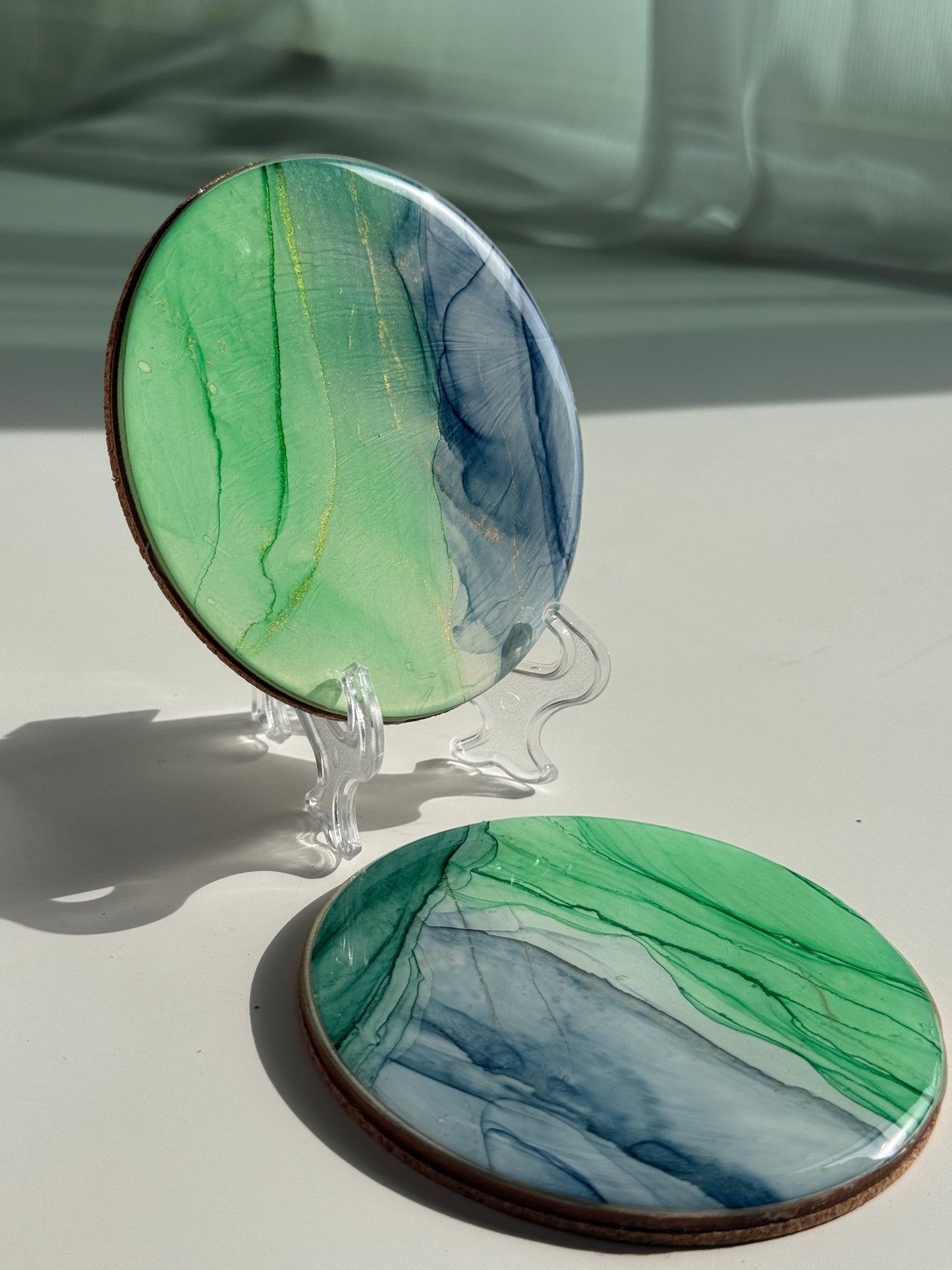 Blue and green alcohol ink coasters