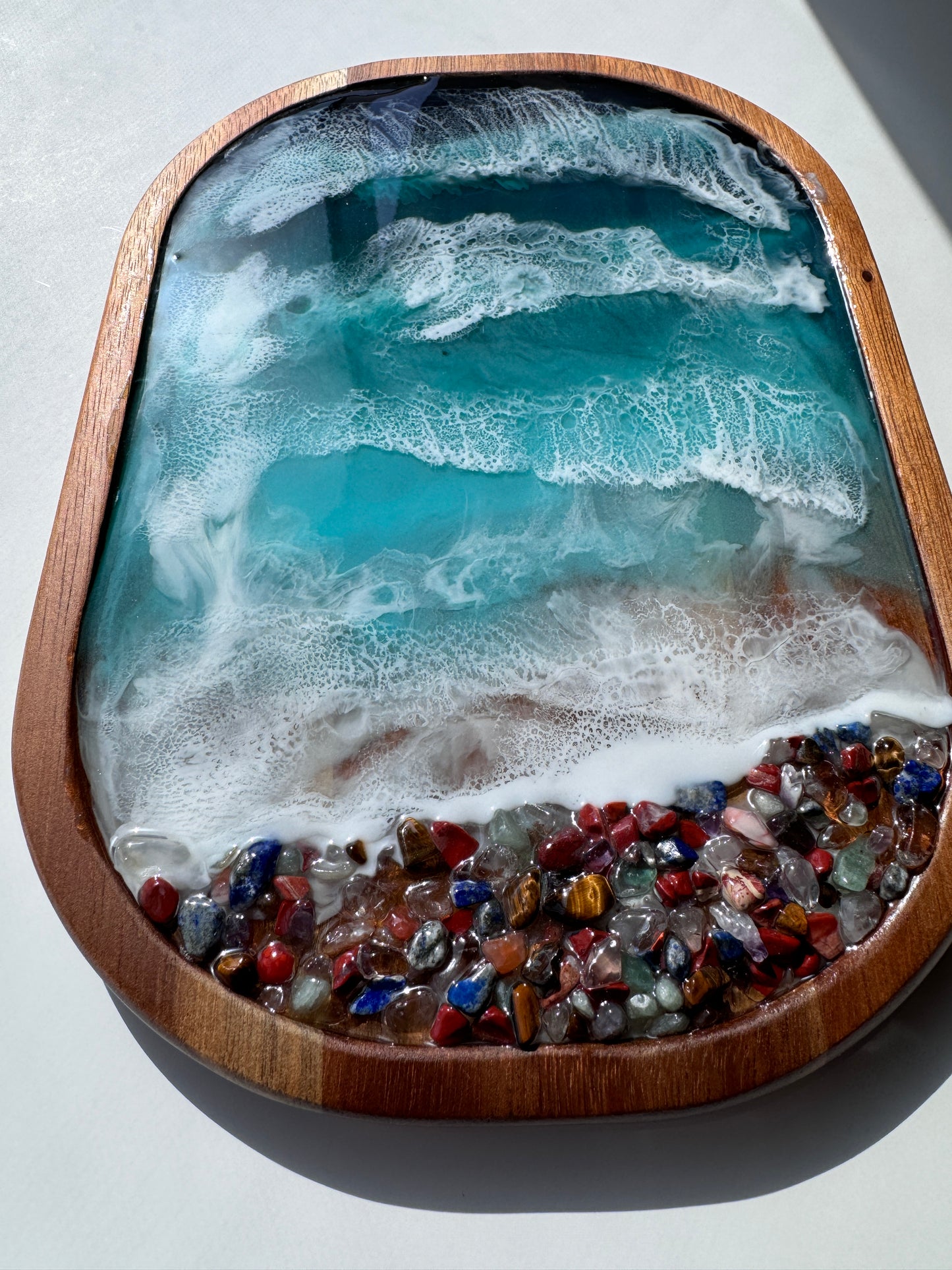 Resin ocean trinket tray with multicolored rocks